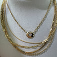 chunky bezel necklace layered with various chains