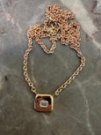 chunky bezel necklace in rose gold with emerald cut diamond